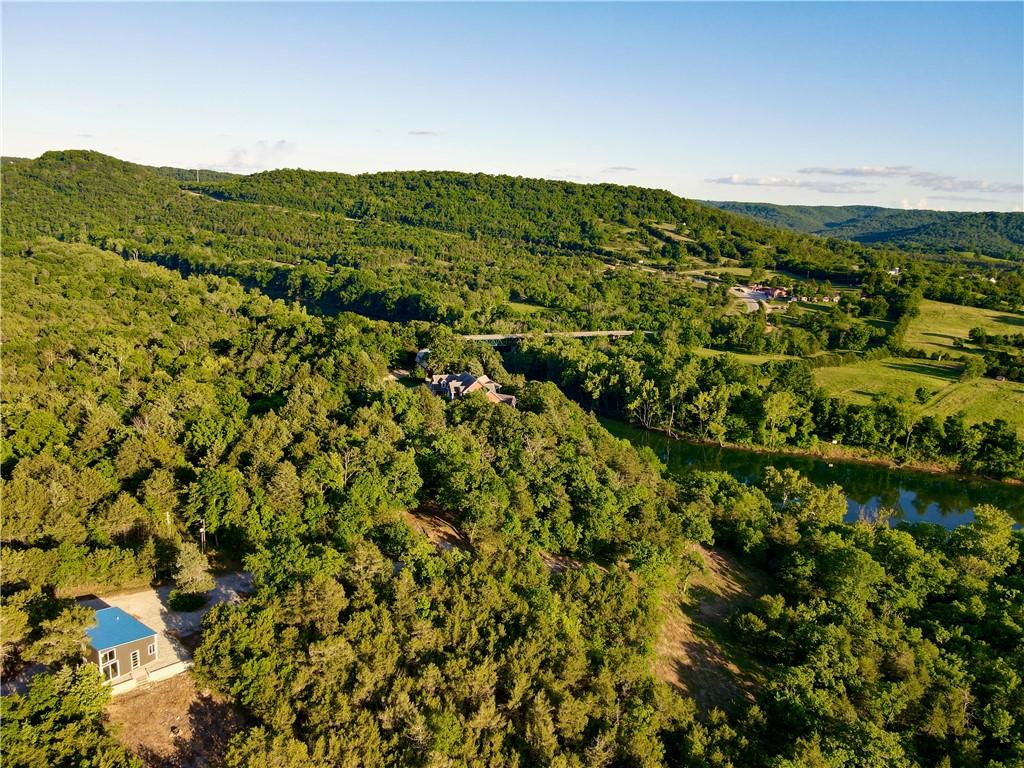 Image 2: Expansive natural landscape featuring lush green h