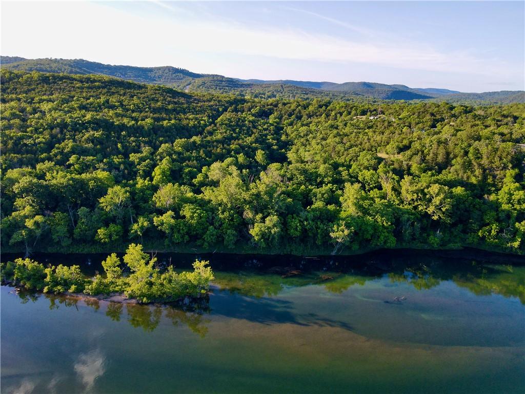 Image 4: Expansive waterfront property featuring mature woo