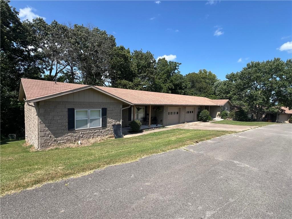 Image 4: Ranch-style exterior with a brown shingle roof and