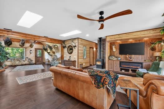 Image 3: Spacious living area featuring rich wood-finish fl