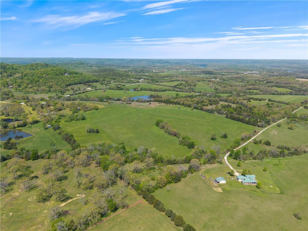 Image 3: Expansive acreage featuring multiple ponds, a wind