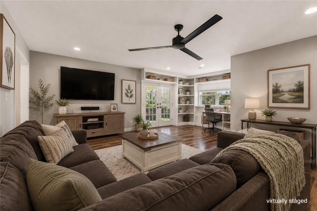 Image 4: Spacious living area featuring wood-finish floorin
