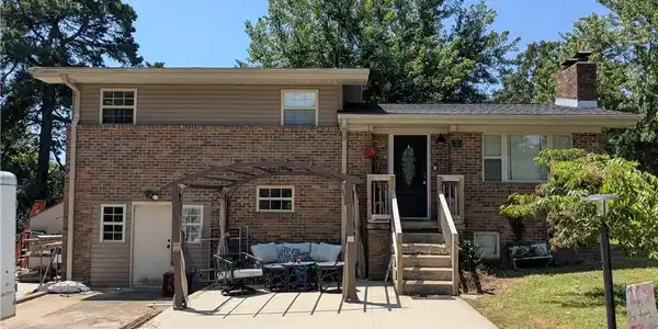 Image 2: Brick and siding exterior featuring a covered fron