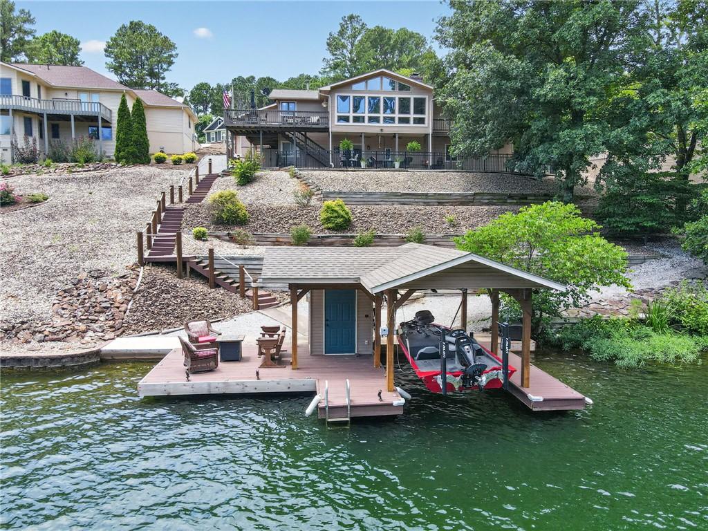 Image 2: Private boat dock with covered slip, featuring a b