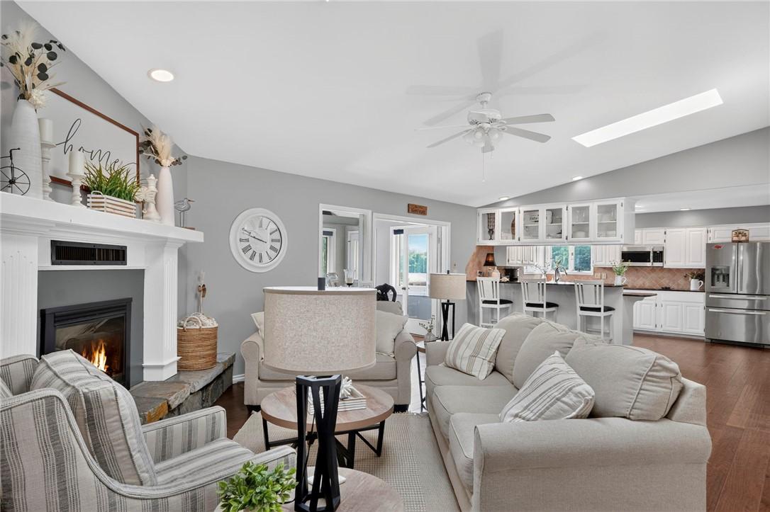 Image 4: Open-concept living area featuring a fireplace wit