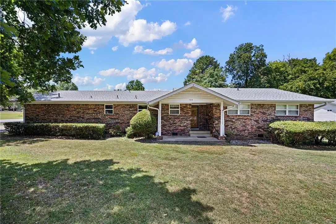 Image 1: Brick exterior with white trim