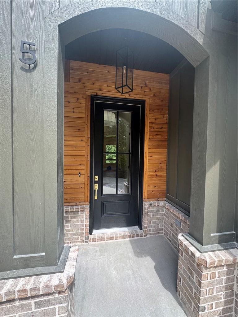 Image 2: Inviting covered entryway featuring a black panele