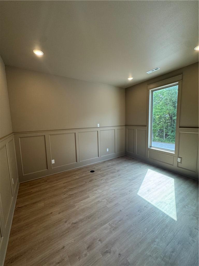 Image 4: Room featuring wainscoting, wood-finish flooring,