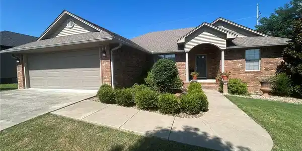 Image 2: Brick exterior with a covered entry and an attache