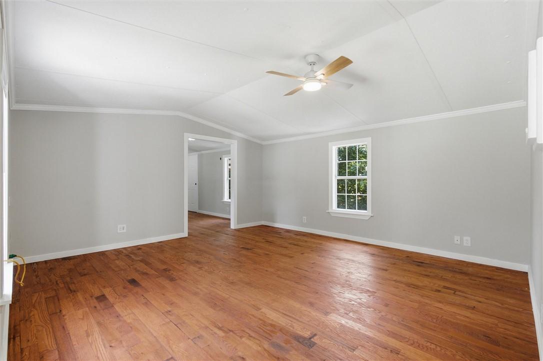 Image 2: Spacious room featuring wood-finish flooring, a ce
