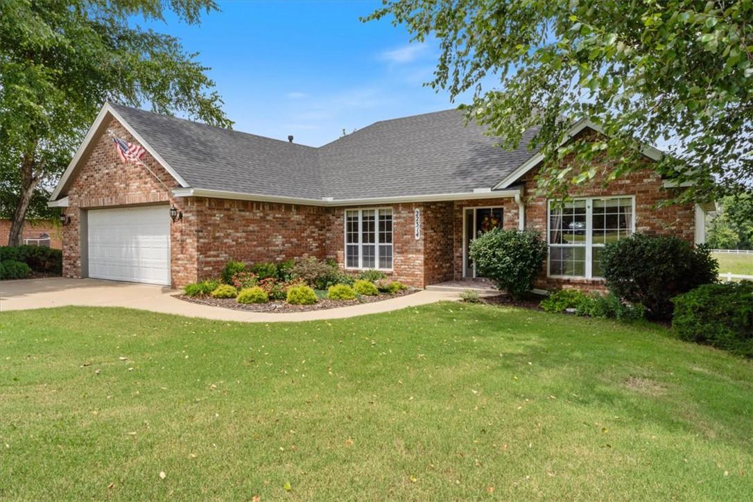 Image 2: Brick exterior residence featuring a two-car garag