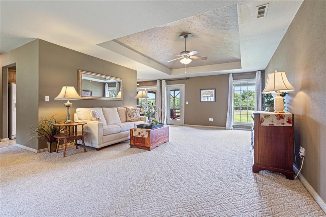 Image 4: Spacious living area featuring patterned carpeting