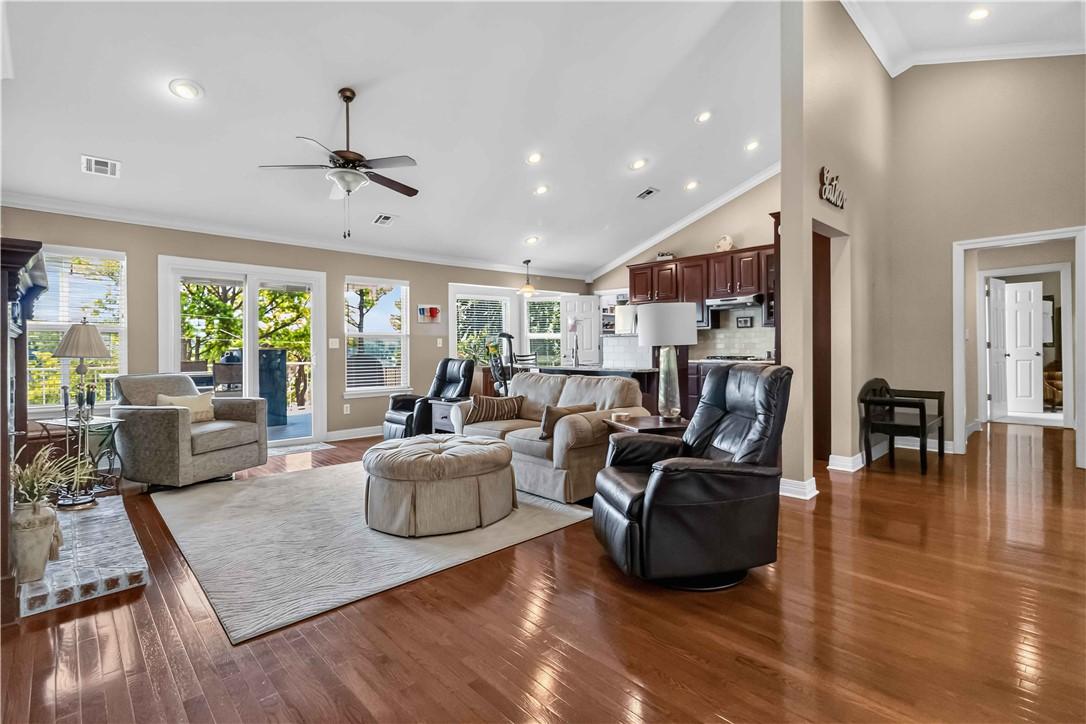 Image 4: Open-concept living area featuring hardwood floori