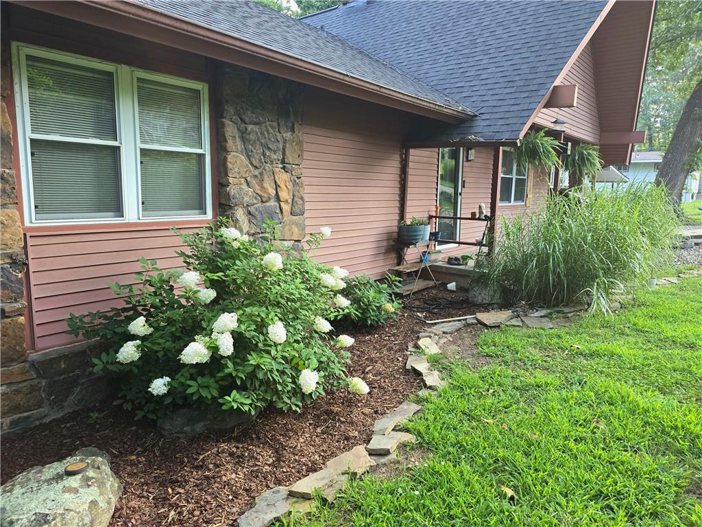 Image 2: Charming brick and siding exterior with mature lan