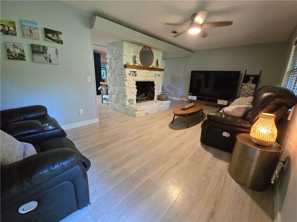 Image 4: Spacious open-concept living area featuring wood-f