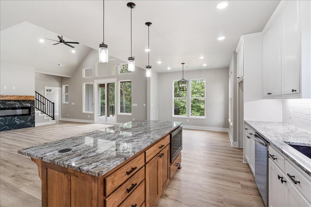 Image 2: Large open kitchen looks into living area with ele