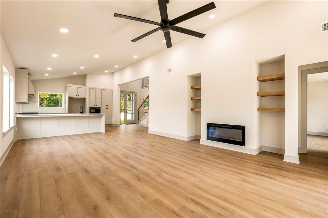 Image 2: Light-toned wood-finish flooring throughout, integ