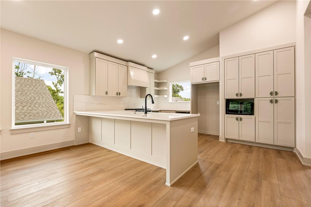 Image 3: Vaulted ceiling, recessed lighting, wood-finish fl