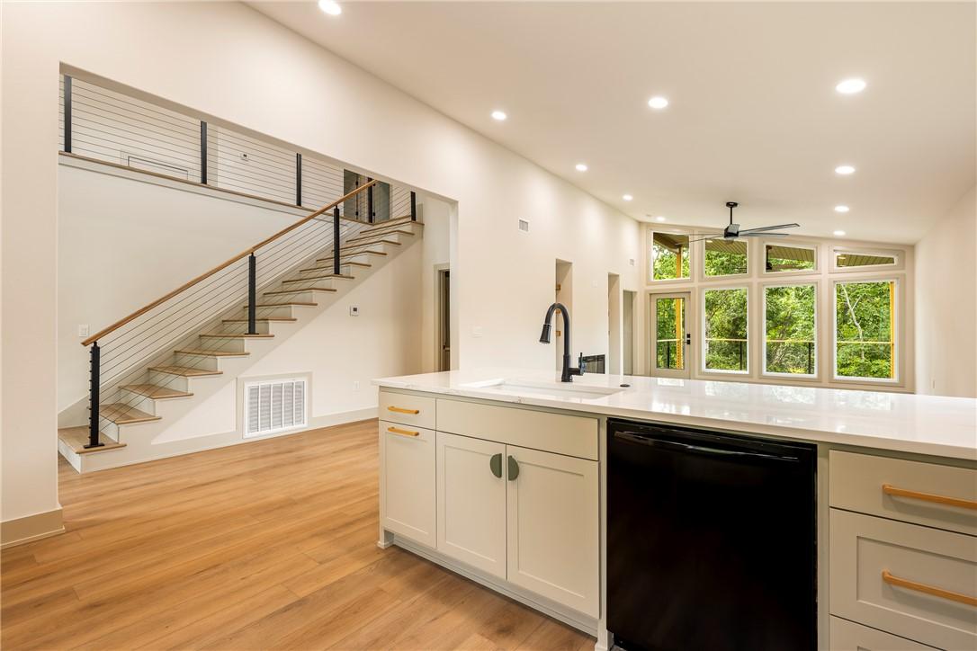 Image 4: Modern kitchen island with a white countertop and