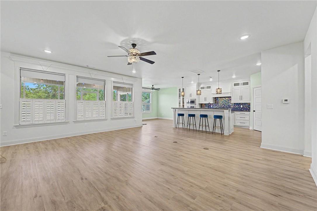 Image 4: Open concept living space featuring wood-finish fl