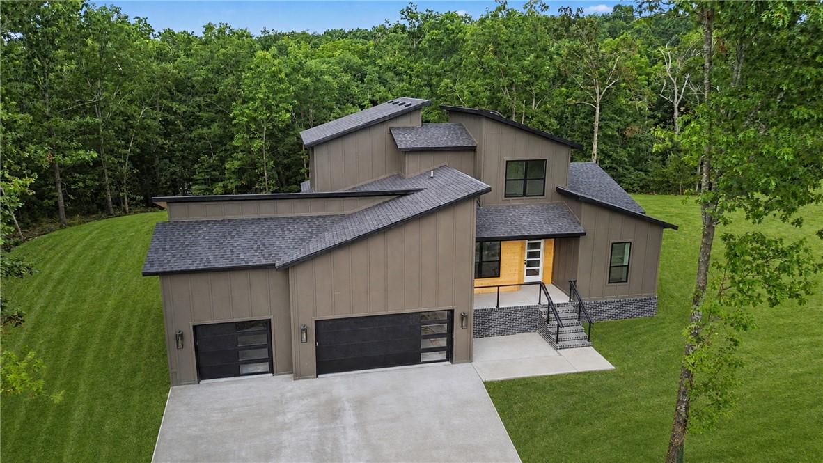 Image 2: Modern exterior with wood-finish siding, dark fram
