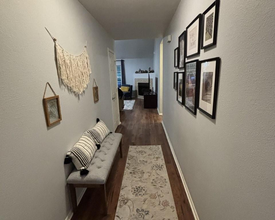 Image 4: Hall featuring a textured wall and dark wood-style