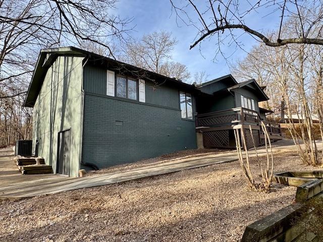 Image 4: View of side of property featuring brick siding, a