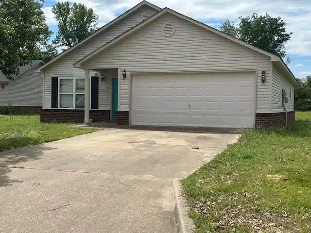 Image 1: Ranch-style exterior with light-colored siding and