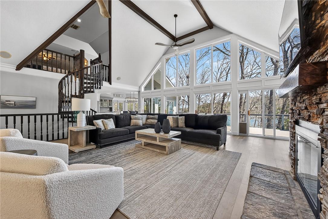 Image 2: Living area with a fireplace, a ceiling fan, and w