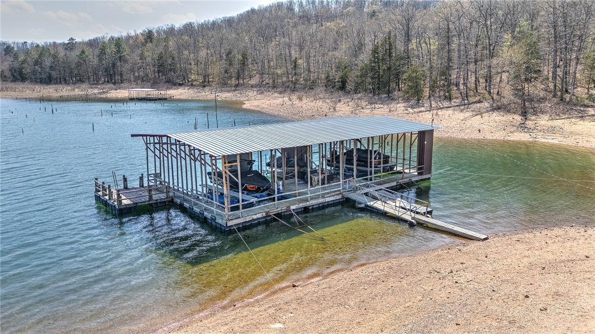 Image 3: Dock area featuring a water view, a forest view, a