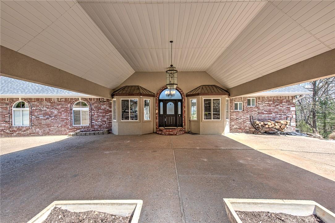 Image 4: Entrance to property with a patio and brick siding