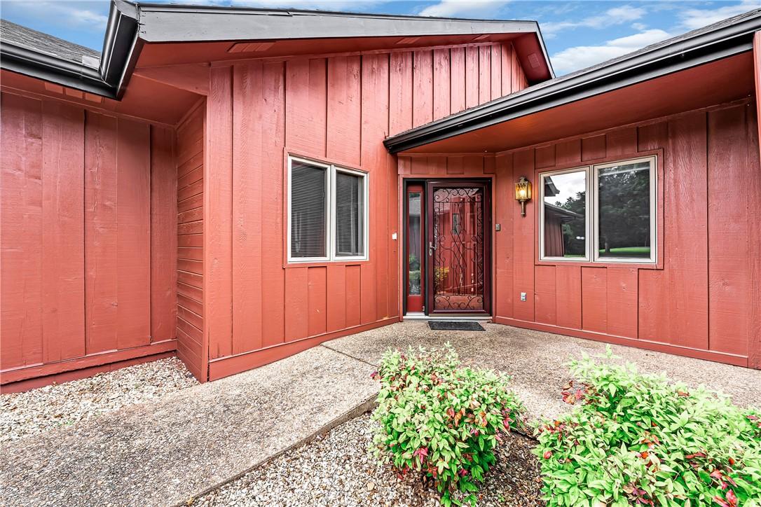 Image 2: Exterior entryway featuring vertical siding, an or