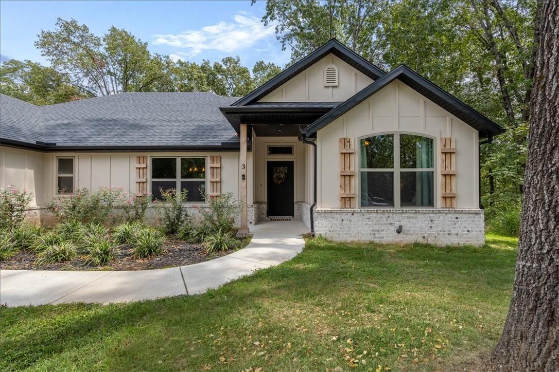 Image 2: Front exterior with curved sidewalk to covered fro