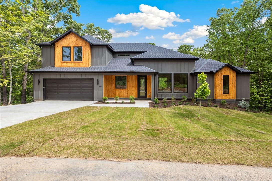 Image 2: Modern exterior featuring board and batten siding