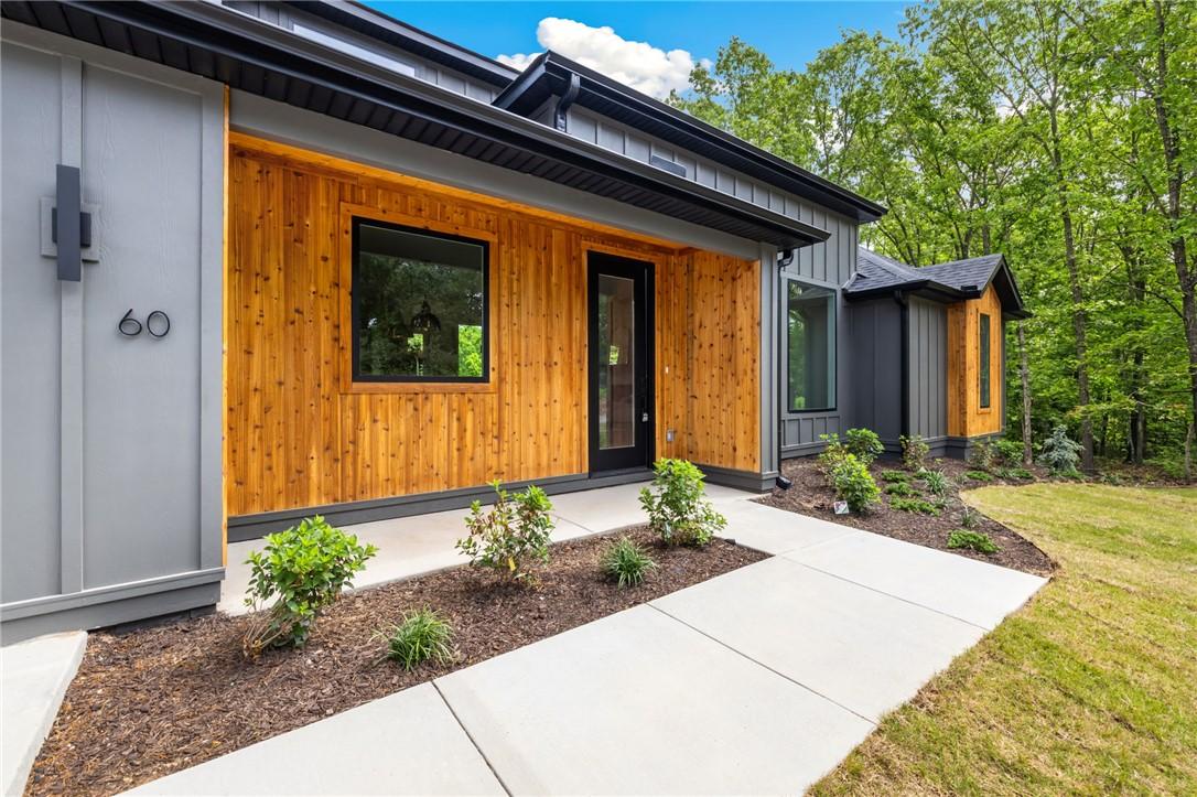 Image 3: Modern exterior featuring vertical siding, natural