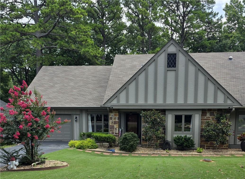 Image 2: Exterior featuring stone veneer and vertical board
