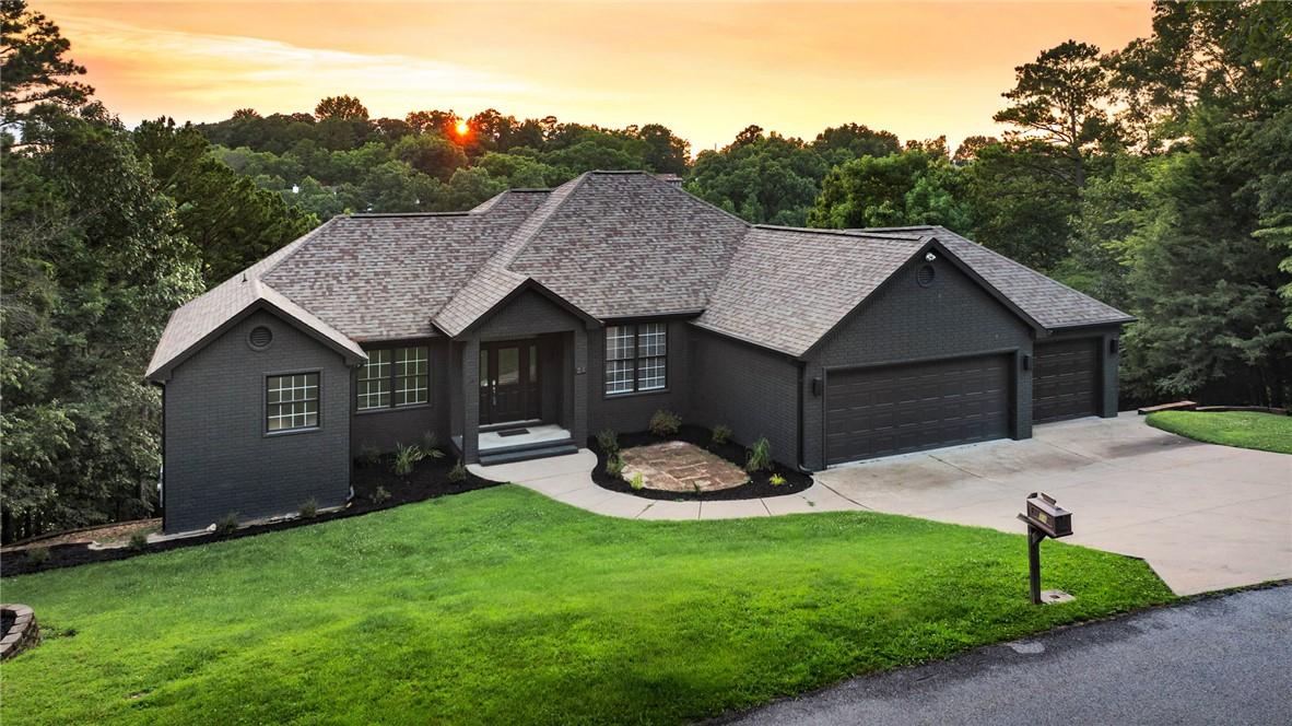 Image 1: Ranch-style residence featuring a dark gray exteri