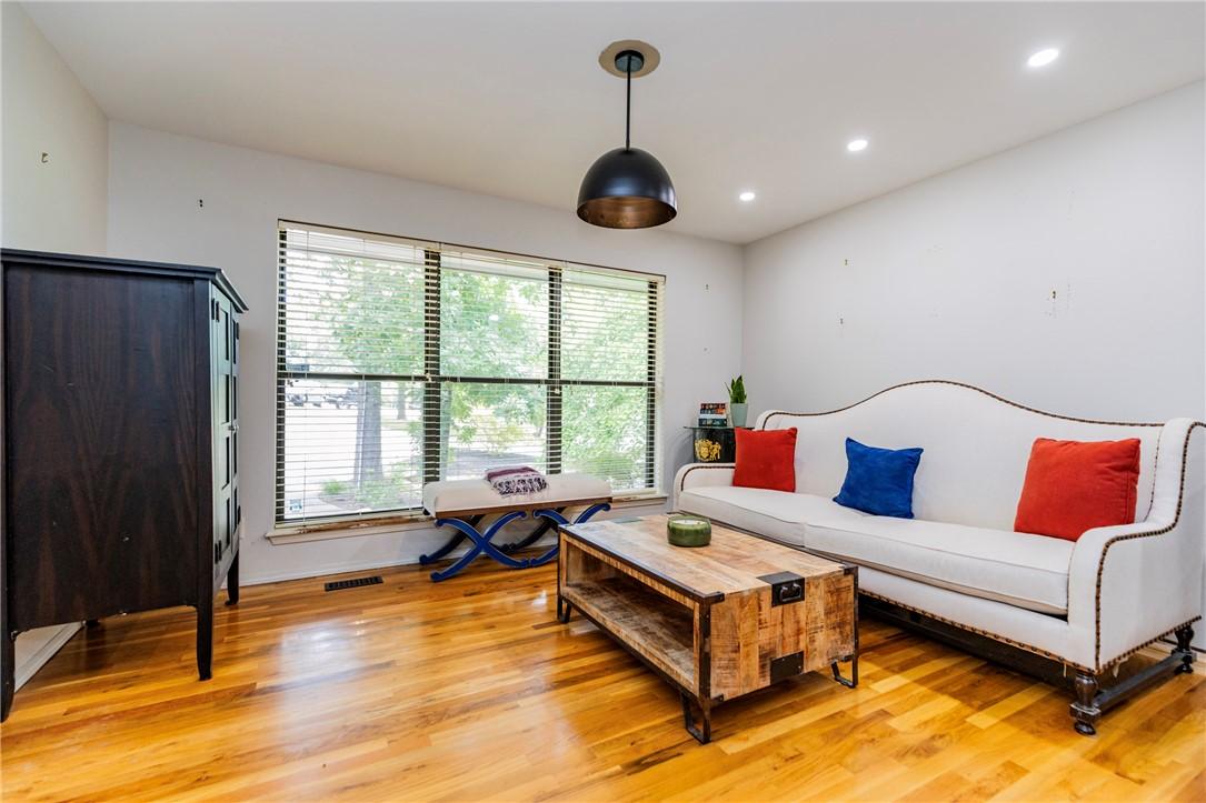 Image 4: Spacious room featuring wood-finish flooring, a la