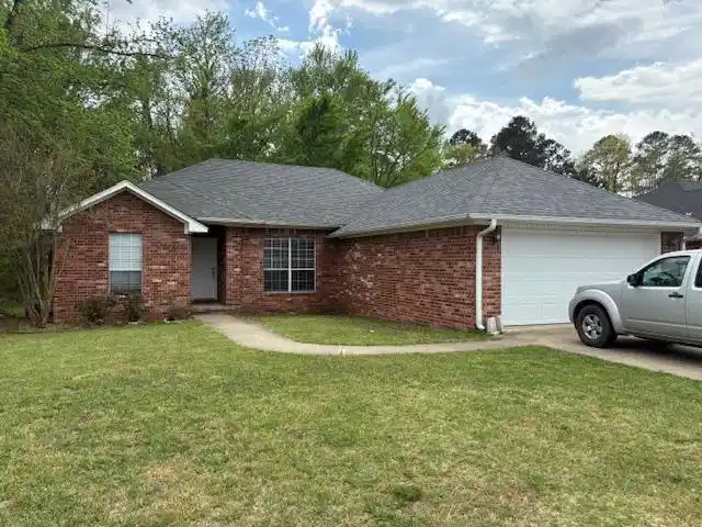 Image 1: Ranch-style house with a garage, a front yard, bri