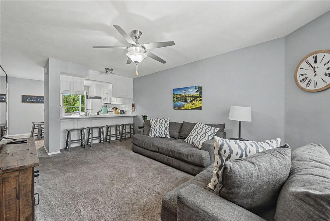 Image 3: Open concept living area featuring wall-to-wall ca