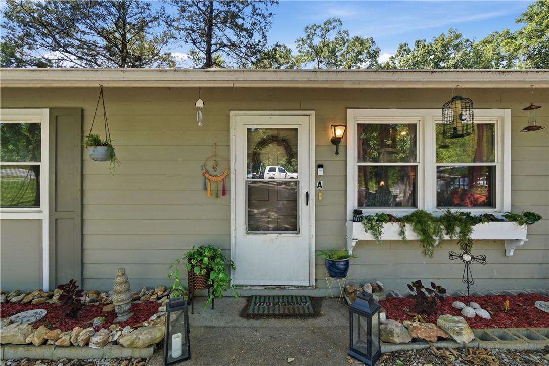 Image 2: Unit A exterior facade with neutral-toned siding