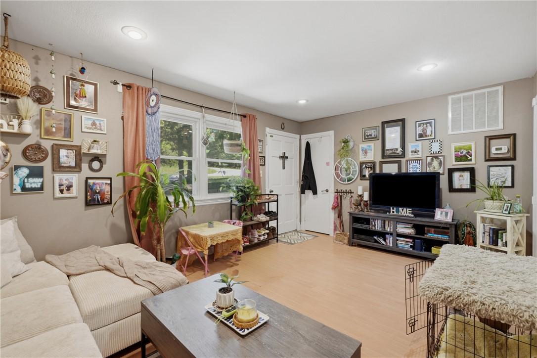 Image 3: Bright living area featuring light-toned wood-fini