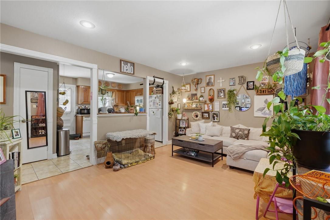 Image 4: Open-concept living area featuring wood-finish flo