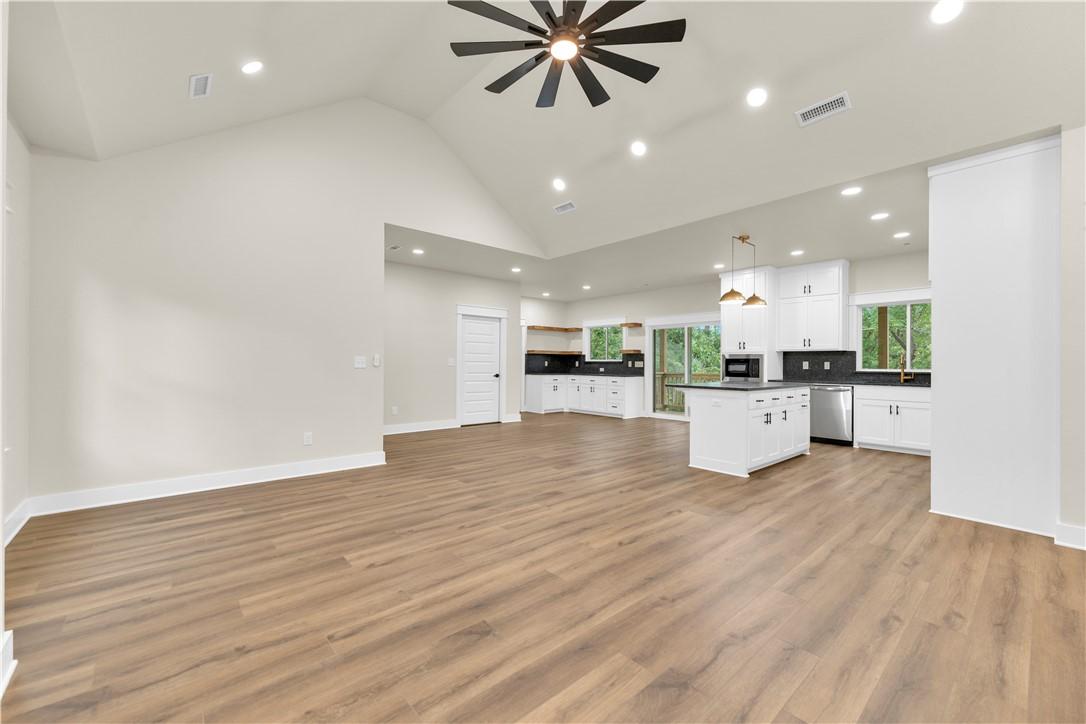 Image 4: Open-concept living area featuring wood-finish flo