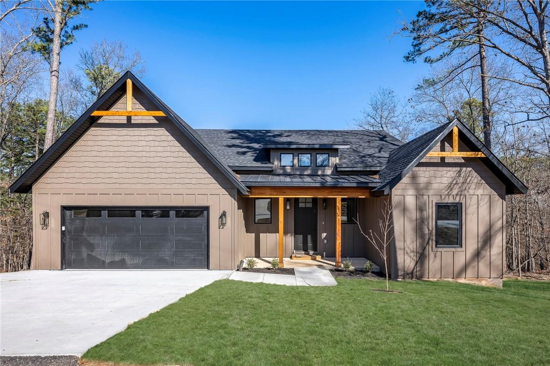 Image 1: Transitional home with board and batten siding, a