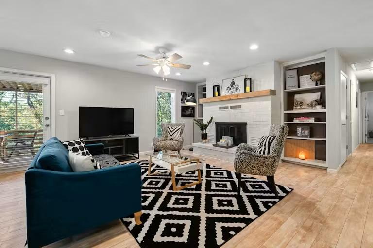 Image 1: Living area featuring light wood-style floors, bui