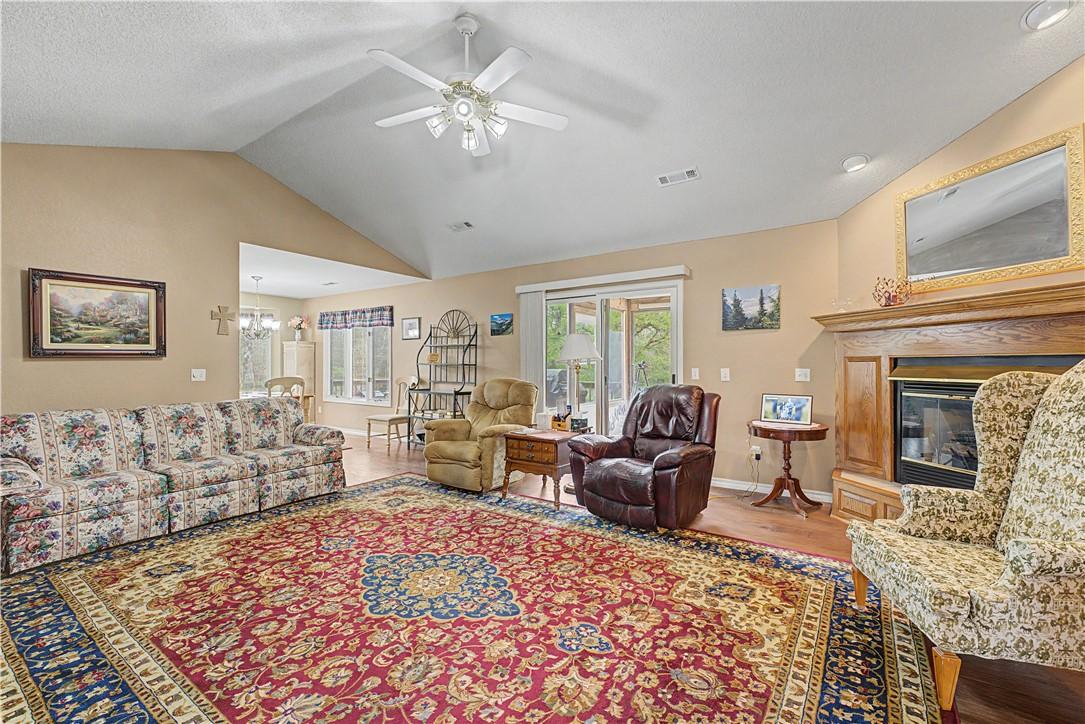 Image 2: Living area with ceiling fan, light wood-style flo