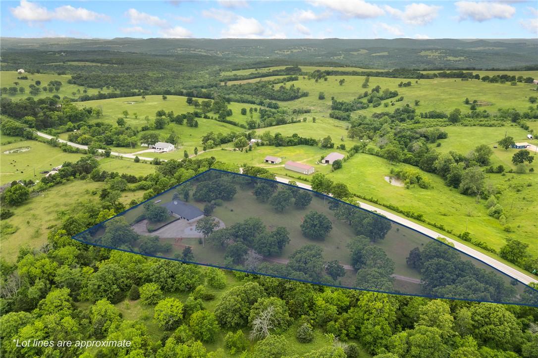 Image 3: Expansive rural acreage featuring a single-story r