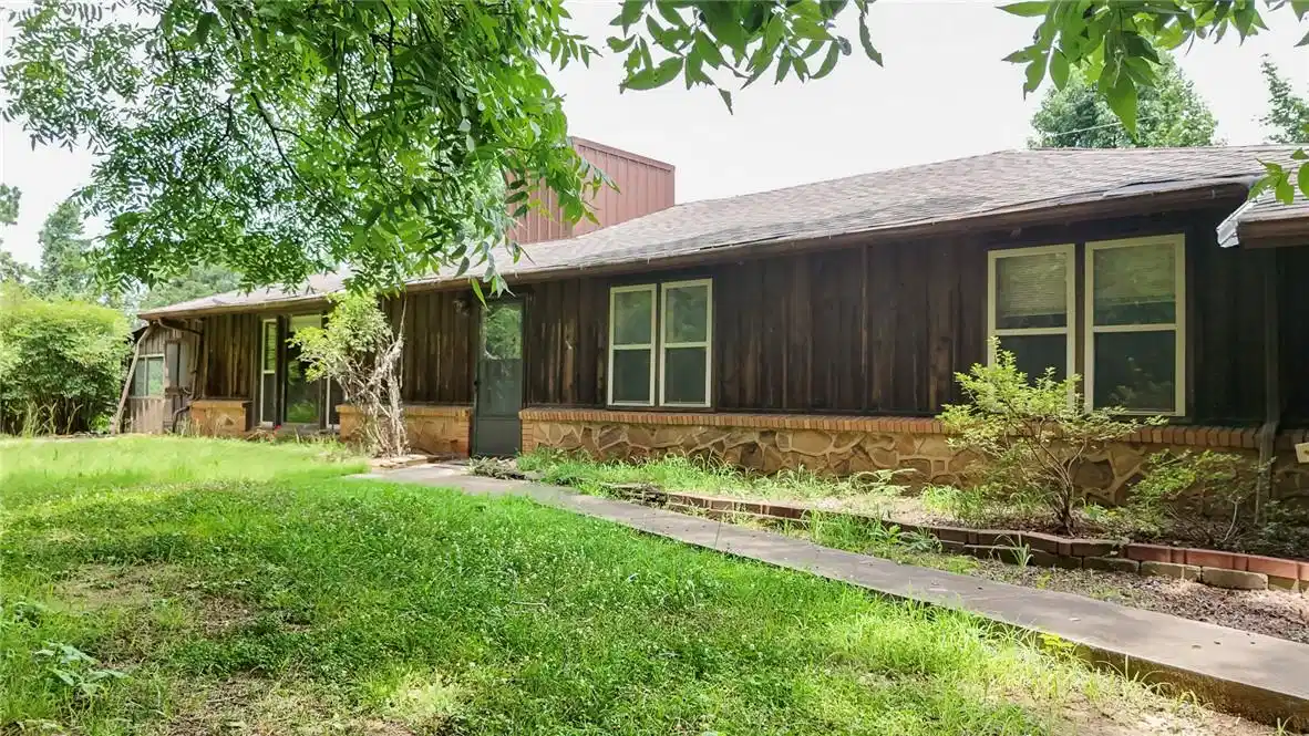 Image 1: Exterior featuring wood paneling, a stone foundati