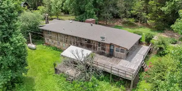 Image 2: Multi-level exterior featuring wood siding and a s